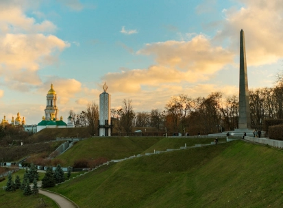 Park of Eternal Glory in Kyiv - sunset landscape with the Obelisk, Holodomor Memorial, and Lavra domes