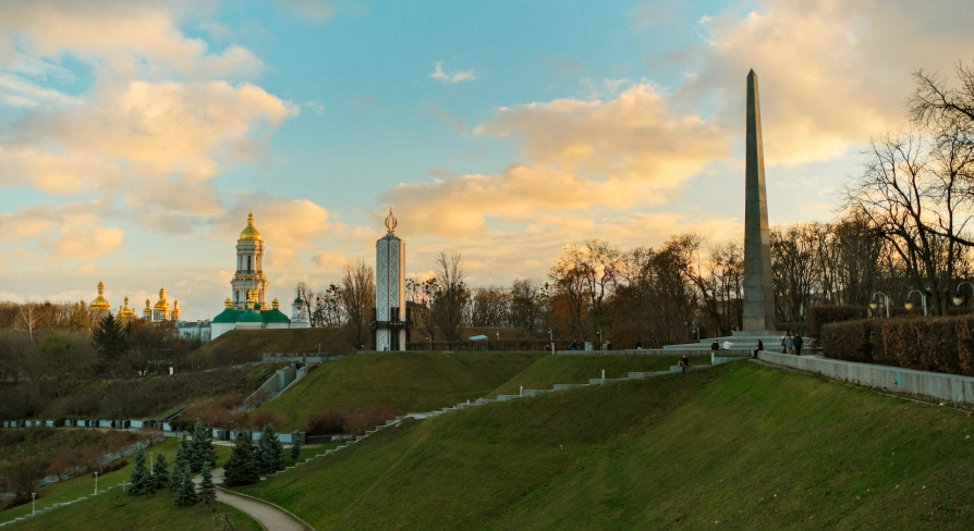 Park of Eternal Glory in Kyiv - sunset landscape with the Obelisk, Holodomor Memorial, and Lavra domes