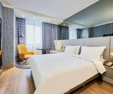 Spacious modern room at the Radisson Blu Hotel in the center of Kyiv with a double bed and a seating area