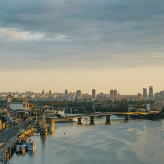 Dnipro river - sunset view of Havanskyi Bridge and Podil embankment skyline