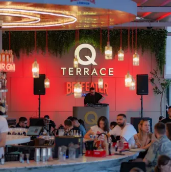 Q Terrace - an indoor dining area with elegant modern furniture and a bar