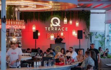 Q Terrace - an indoor dining area with elegant modern furniture and a bar