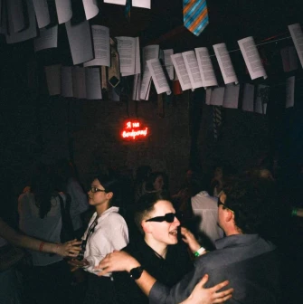 Vechirochka - party interior with papers and ties hanging from ceiling