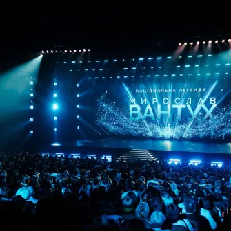 Palats Ukraina in Kyiv - packed concert hall bathed in blue light with the name of Myroslav Vantukh shining on the stage screen