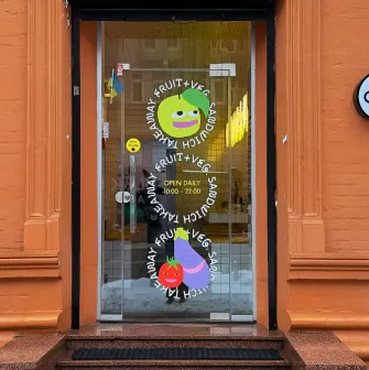 Fruit & Veg - light green painted cafe facade with large windows and simple sign