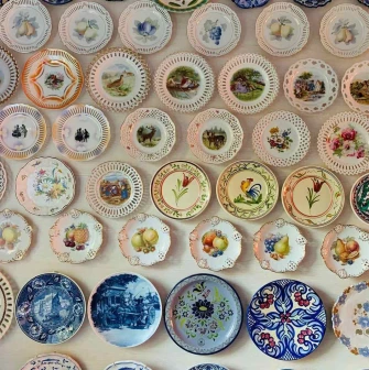 A collection of decorative plates with floral and ethnic paintings at the Eatmyvintage vintage fair