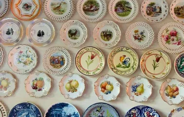 A collection of decorative plates with floral and ethnic paintings at the Eatmyvintage vintage fair