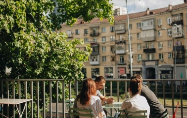 Octo Tower - outdoor terrace with people sitting at table under tree