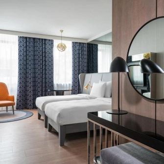 Modern room at the Radisson Blu Hotel in the center of Kyiv with two beds and designer furniture