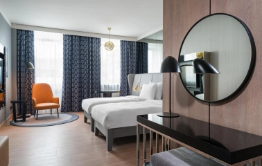 Modern room at the Radisson Blu Hotel in the center of Kyiv with two beds and designer furniture