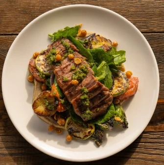 Meat dish with vegetables and sauce at Shalom restaurant