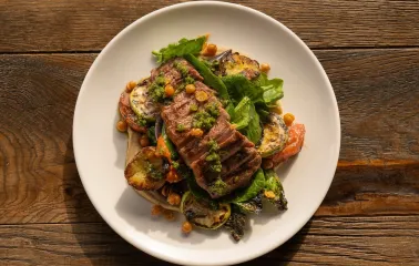 Meat dish with vegetables and sauce at Shalom restaurant