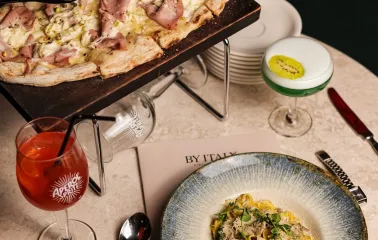 By Italy – truffle pasta and mortadella pizza served with Aperol Spritz and signature cocktail