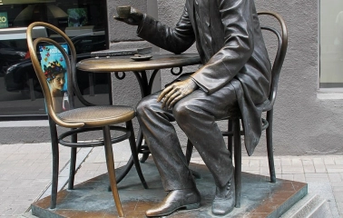 Pasazh in Kyiv - bronze statue of architect Horodetskyi drinking coffee at a table