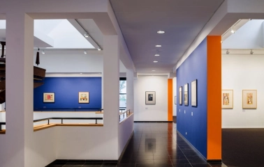 Art gallery with works on blue walls at Mystetskyi Arsenal