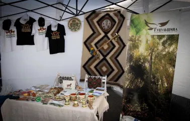Interior of a pavilion featuring a crafts exhibition, ceramics, a carpet, and Hutsulshchyna t-shirts