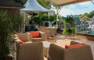 Restaurant Terasa - sunny rooftop lounge with wicker furniture and a small white tent