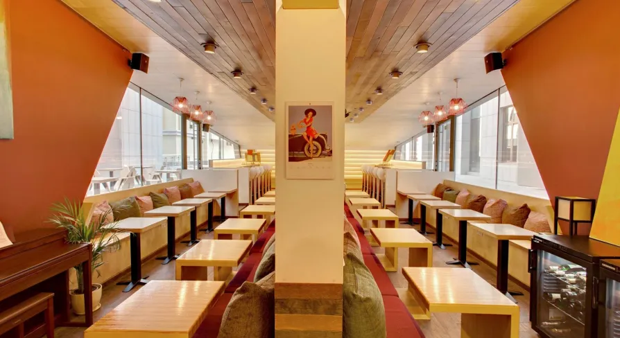 One Love Coffee in Kyiv - symmetrical cafe interior with orange walls and wood ceiling