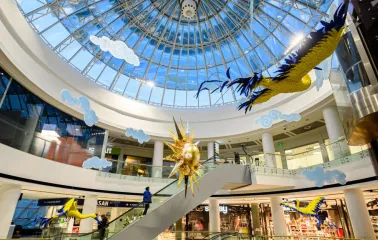 Interior of the Globus shopping center with a transparent dome and bright art installations