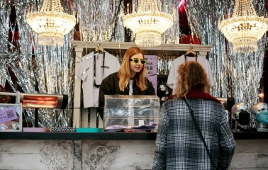 Seller of a bright glam stand with chandeliers at the Kurazh market in Kyiv