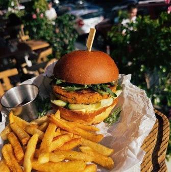 Restaurant Trishky Bilshe - close-up of a veggie burger and french fries on an outdoor table