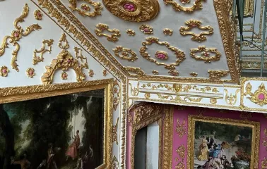 The “Versailles” Stairwell - ceiling adorned with gold moldings and classical paintings