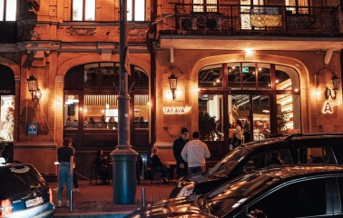 Takava in Kyiv - evening view of brick cafe facade with arched windows and lights