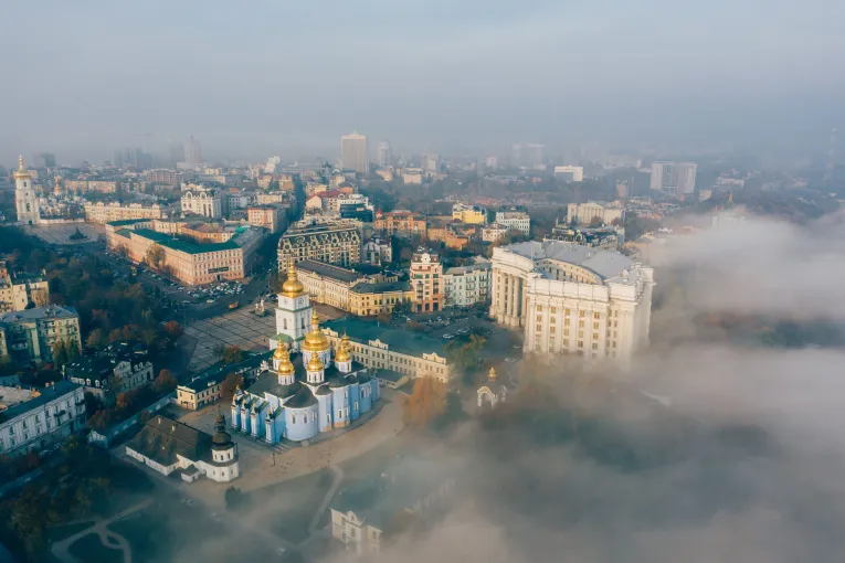 Aerial view of Kyiv city centre with St. Michael’s Golden-Domed Monastery and surrounding landmarks covered in morning fog