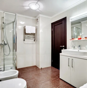 A clean and modern bathroom with a glass shower cabin at the Bratyslava Hotel in Kyiv