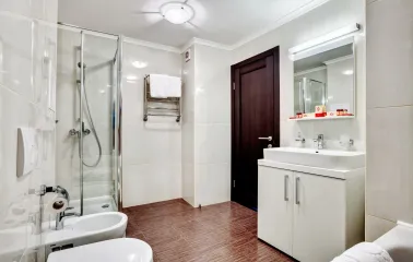 A clean and modern bathroom with a glass shower cabin at the Bratyslava Hotel in Kyiv