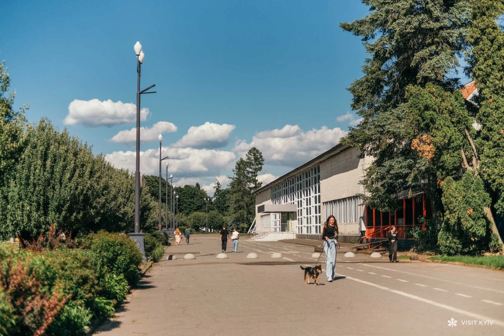 A girl walks her dog on the territory of VDNH near Patron Pet Center in Kyiv