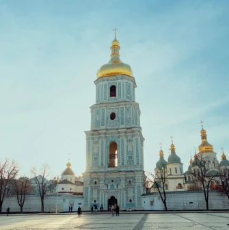Saint Sophia Cathedral in Kyiv - bell tower exterior with golden dome against blue sky