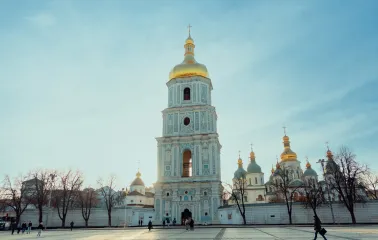 Saint Sophia Cathedral in Kyiv - bell tower exterior with golden dome against blue sky