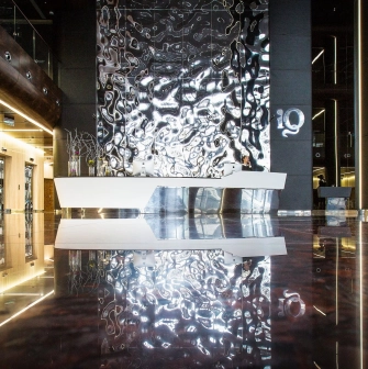 IQ Business Center in Kyiv - lobby featuring shiny metallic reception desk and wavy wall