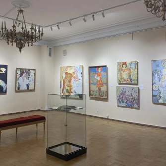 Muzei Suchasnoho Mystetstva in Kyiv - elegant exhibition hall with crystal chandeliers and parquet flooring showcasing large colorful canvas paintings