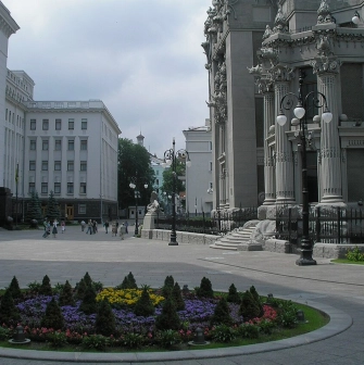 Budynok Horodetskoho in Kyiv - majestic grey facade with columns rising above the flowerbed