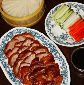 Restaurant Kytaiskyi Pryvit - close-up of sliced duck meat fresh vegetables and sauce