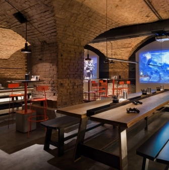 Punkraft - cozy interior space with brick walls wooden tables and warm lighting