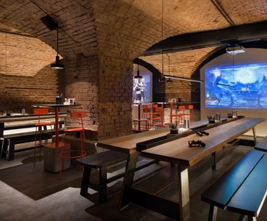 Punkraft - cozy interior space with brick walls wooden tables and warm lighting