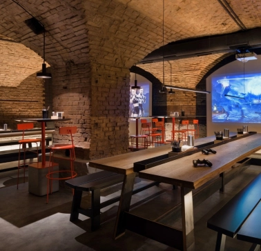Punkraft - cozy interior space with brick walls wooden tables and warm lighting