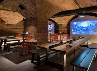 Punkraft - cozy interior space with brick walls wooden tables and warm lighting