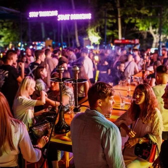 Fifty Club - guests smoking hookah and talking at outdoor bar