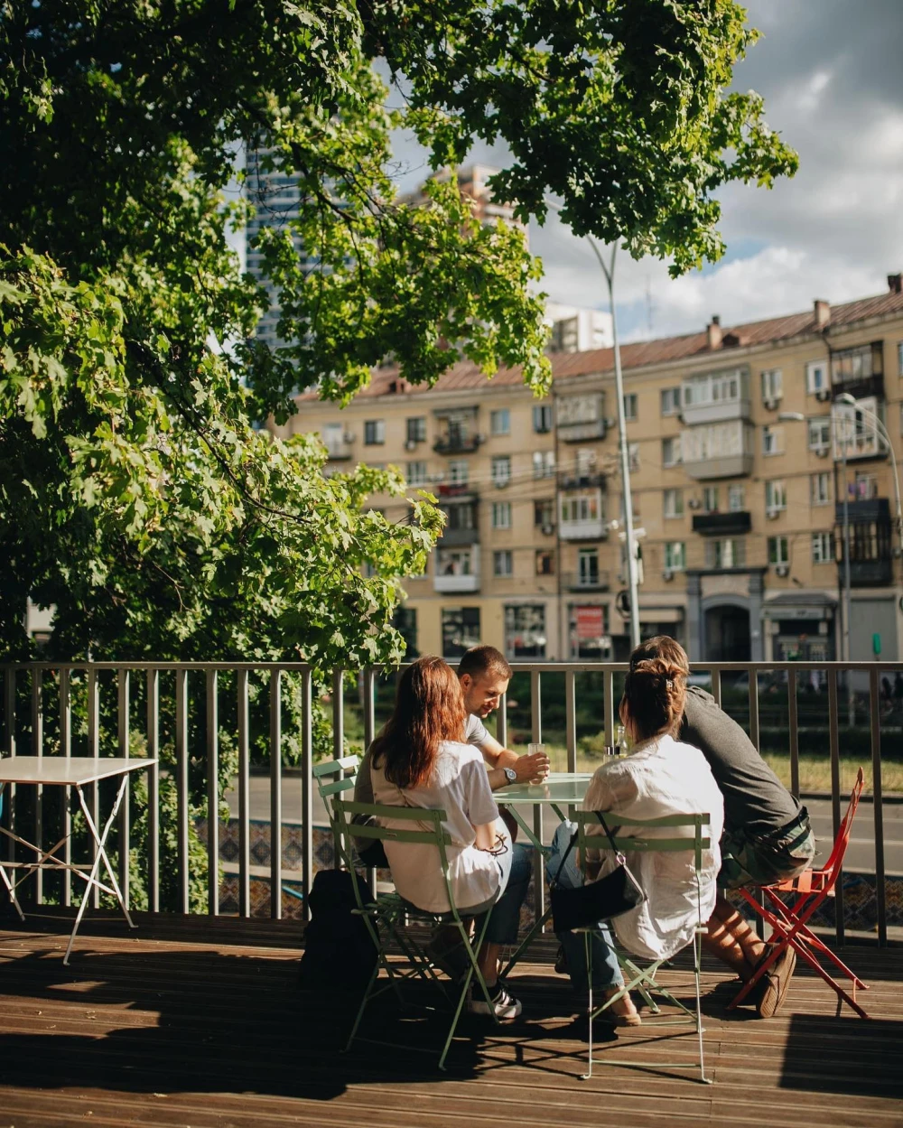 Octo Tower - outdoor terrace with people sitting at table under tree