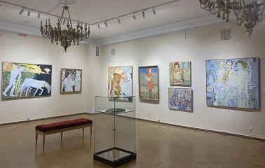 Muzei Suchasnoho Mystetstva in Kyiv - elegant exhibition hall with crystal chandeliers and parquet flooring showcasing large colorful canvas paintings