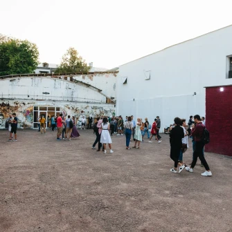 Lavra Gallery in Kyiv - a crowd of people spending time in a spacious white brick courtyard during an art event