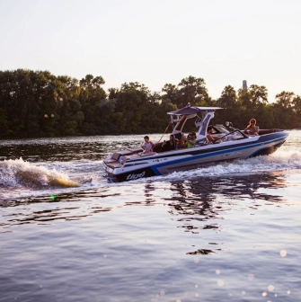 X-Park in Kyiv - motorboat towing a wake surfer on the shimmering river water