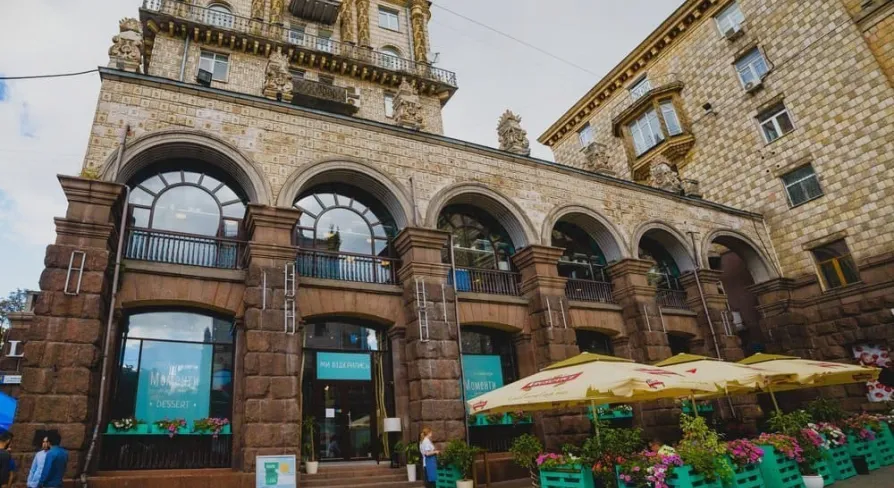 Restaurant Momenty - historic stone facade with arched windows and outdoor terrace