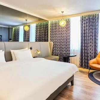 Room at the Radisson Blu Hotel in the center of Kyiv with a king-size bed and a seating area