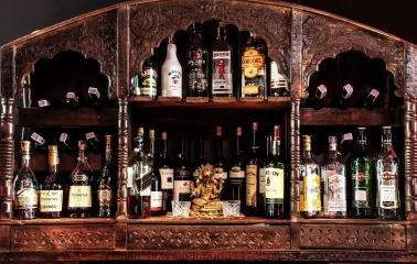 Collection of alcoholic beverages on a carved wooden shelf