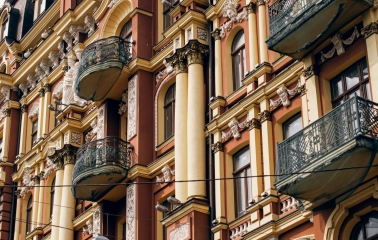 Syrotkin House - metal balconies and columns on the ornate historical facade